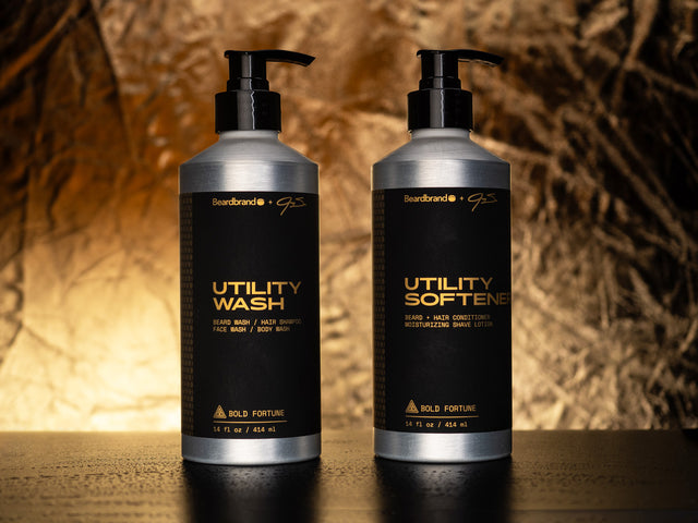 Bold Fortune Utility Wash and Utility Softener side by side against a shadowed golden backdrop with a creased texture.
