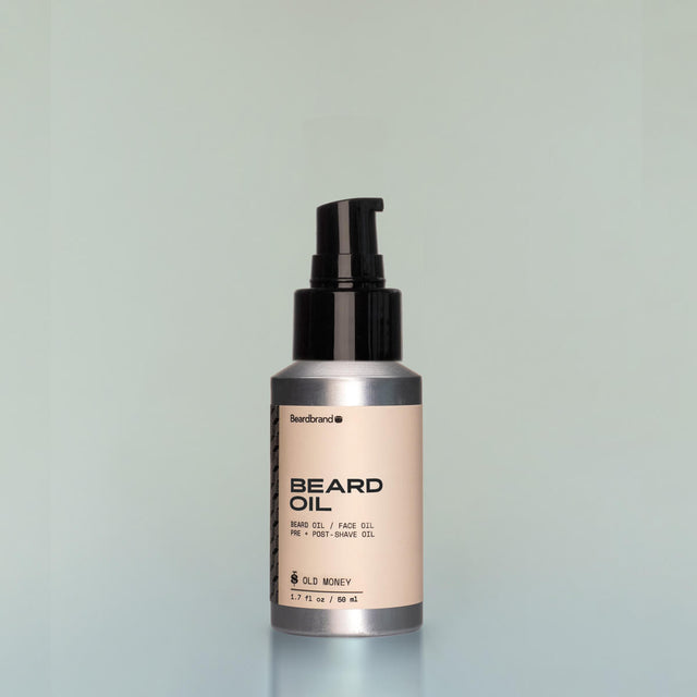 A bottle of Old Money travel-size Beard Oil with a pump dispenser against a grey background.