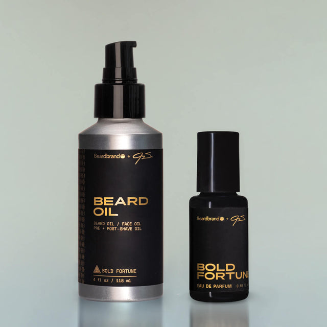 A bottle of Bold Fortune Beard Oil and Bold Fortune Eau de Parfum against a grey background.