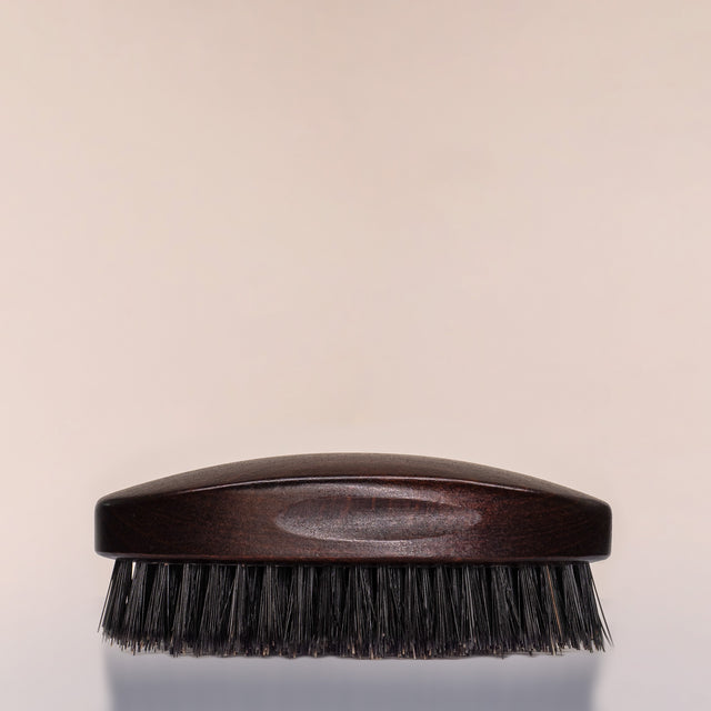 A Beardbrand 100% Boar’s Hair Oval Brush side view.