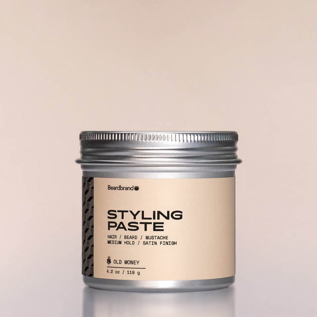 A container of Styling Paste against a neutral background.
