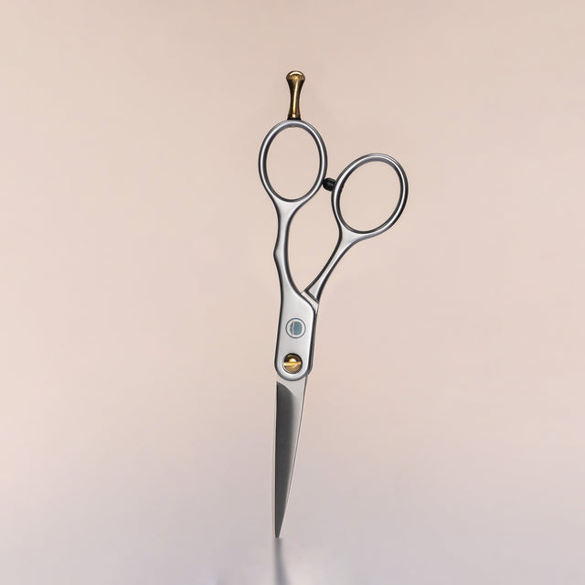 A pair of Beardbrand Beard Trimming Scissors against a neutral background.