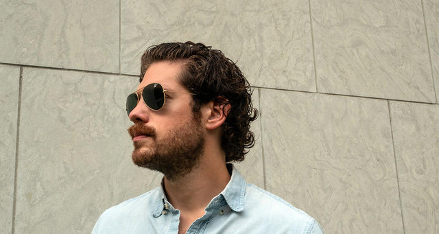 Man with curly coarse hair wearing Ray-Ban Aviators 