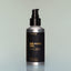 A bottle of Four Vices full-size Beard Oil with a pump dispenser against a grey background.