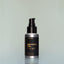 A bottle of Four Vices travel-size Beard Oil with a pump dispenser against a grey background.