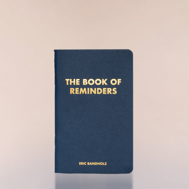 The Book of Reminders by Eric Bandholz against a neutral background.