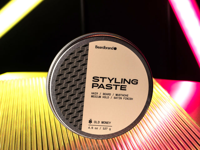 Styling Paste in an aluminum tin against a yellow and pink neon backdrop