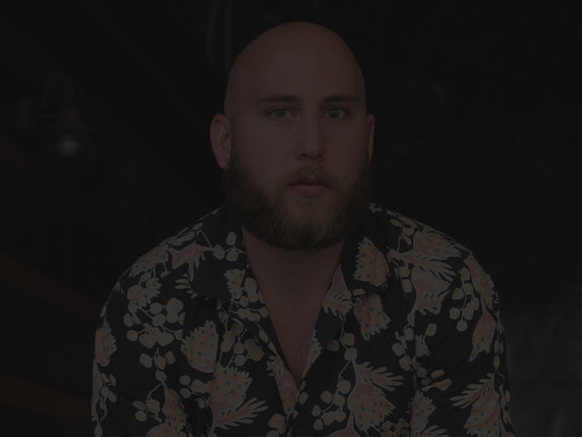 A portrait of a bald beardsman