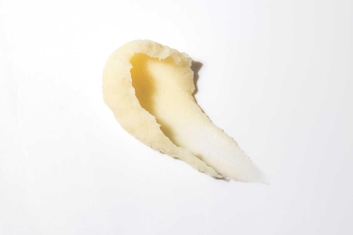 A scoop of Beard Balm smeared across a flat, white surface.