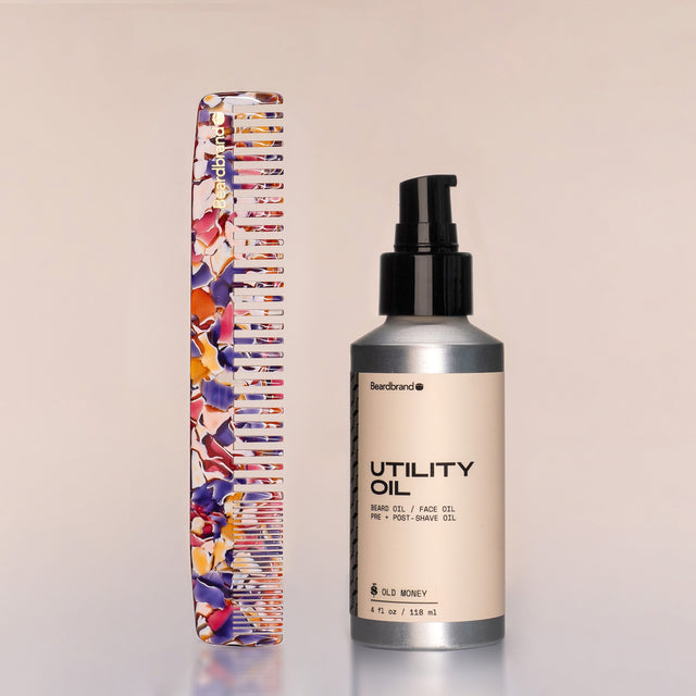 A Large Comb in Unicorn Vomit acetate standing upright next to a bottle of Utility Oil against a neutral background.