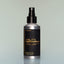 A bottle of Norse Winter Utility Deodorant with a spray dispenser against a grey background.