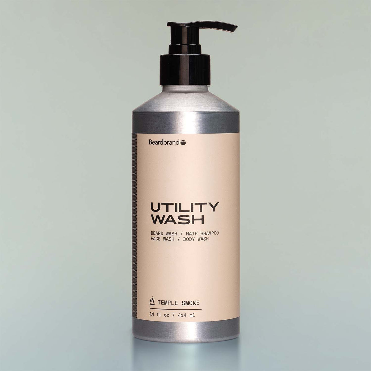 A bottle of Temple Smoke Utility Wash with a pump dispenser against a grey background.