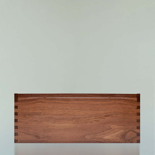 The black walnut Beardbrand Beardsman’s Box shown from the front with the lid closed.