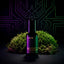 Ghost Tracer Eau de Parfum bottle by Beardbrand placed in front of vibrant green moss with a neon circuit-style background. Image reflects a futuristic, earthy fragrance with notes of rain, moss, ozone, and violet leaf.