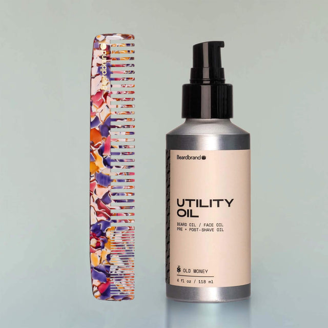 A Large Comb in Unicorn Vomit acetate standing upright next to a bottle of 
Old Money Utility Oil.