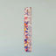 A Large Comb in Unicorn Vomit acetate standing upright against a grey background.